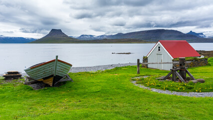 buildings and boats on the remote island of Vigur, on the Icelandic north western coast during...