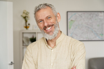 Smiling relaxed mature older bearded hipster man looking at camera. Happy handsome confident middle...