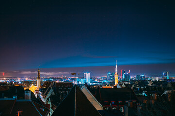 Fototapeta premium Tallinn, Estonia, Europe. Natural Night Starry Sky Above Tallinn Skyline Cityscape. Old Town And Modern City. Popular Place With Famous Landmarks. UNESCO