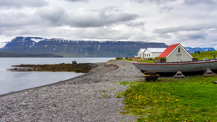 buildings and boats on the remote island of Vigur, on the Icelandic north western coast during...