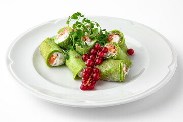 Pancakes rolls stuffed with salmon, spinach, Philadelphia cheese. Banquet festive dishes. Gourmet restaurant menu. White background.