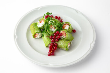 Pancakes rolls stuffed with salmon, spinach, Philadelphia cheese. Banquet festive dishes. Gourmet restaurant menu. White background.