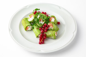 Pancakes rolls stuffed with salmon, spinach, Philadelphia cheese. Banquet festive dishes. Gourmet restaurant menu. White background.