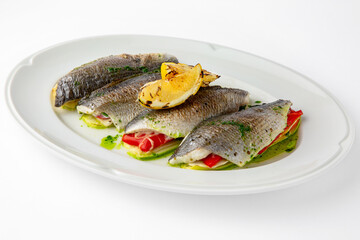 Dorada stuffed with vegetables, baked in the oven with cheese. Banquet festive dishes. Gourmet restaurant menu. White background. 