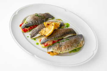 Dorada stuffed with vegetables, baked in the oven with cheese. Banquet festive dishes. Gourmet restaurant menu. White background. 