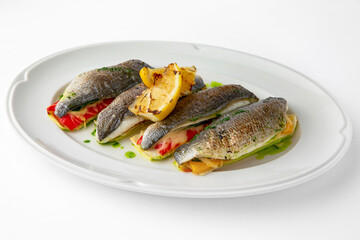 Dorada stuffed with vegetables, baked in the oven with cheese. Banquet festive dishes. Gourmet restaurant menu. White background. 