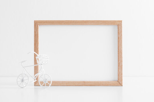 Brown wood frame mockup on white table. Front view. Place for text, copy space, mockup