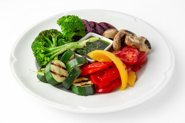 Appetizer of grilled vegetables from zucchini, eggplants, tomatoes, sweet peppers, onions. Rolls stuffed with cheese. Banquet festive dishes. Gourmet restaurant menu. White background.