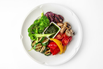 Appetizer of grilled vegetables from zucchini, eggplants, tomatoes, sweet peppers, onions. Rolls stuffed with cheese. Banquet festive dishes. Gourmet restaurant menu. White background.