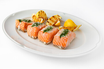 Large pieces of fillet baked with salmon cheese and sauce. Banquet festive dishes. Gourmet restaurant menu. White background.