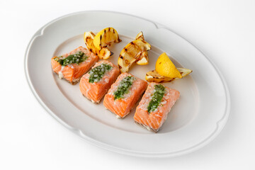 Large pieces of fillet baked with salmon cheese and sauce. Banquet festive dishes. Gourmet restaurant menu. White background.