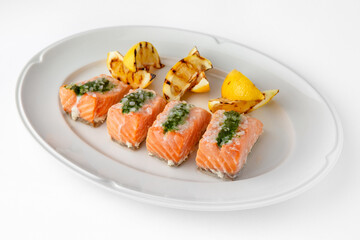 Large pieces of fillet baked with salmon cheese and sauce. Banquet festive dishes. Gourmet restaurant menu. White background.
