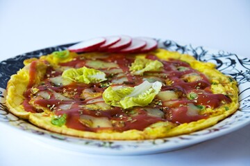 Juicy pizza omelet with ham and spring onions, spices, lettuce, radishes, topped with tomatoes and melted cheese