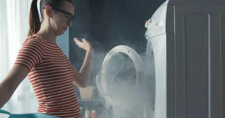 Woman staring at the broken washing machine