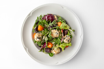Vegetarian salad with balls of tofu and nuts, roasted beets, carrots and greens. Banquet festive dishes. Gourmet restaurant menu. White background.