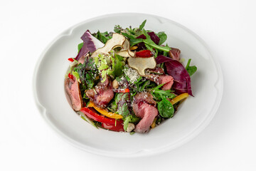 Salad with beef, vegetables and herbs. Banquet festive dishes. Gourmet restaurant menu. White background.