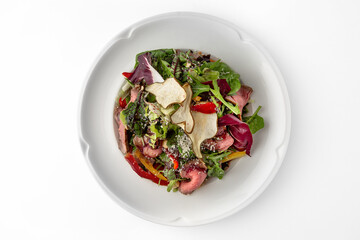 Salad with beef, vegetables and herbs. Banquet festive dishes. Gourmet restaurant menu. White background.