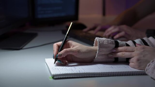 Team work of two colleagues from IT sphere and developing new software in front of computer. Macro footage of man and woman hands discussing and typing new html code line. Programmers are doing a job.