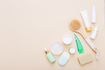Top view of natural skincare and spa cosmetic products on beige background. Beauty concept