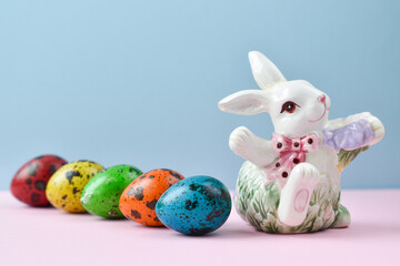 Porcelain hare and colored quail eggs. Easter. multicolored.