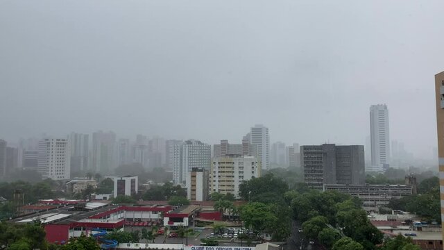 Light rain with skyline of buildings in the background. 