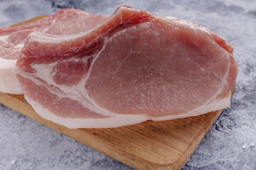 Raw fresh meat. Raw pork steak on a wooden board.