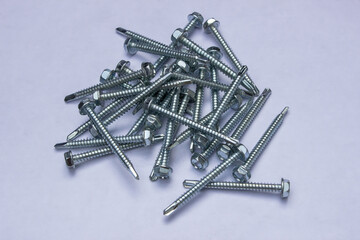 Stainless wood screws and bolts on white background close up macro, as background