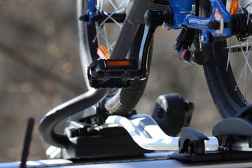 close up of a bicycle wheel on the roof of the car