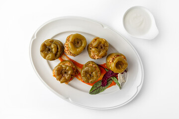 Sweet peppers stuffed with rice, vegetables and meat, baked in the oven. Banquet festive dishes. Gourmet restaurant menu. White background. 