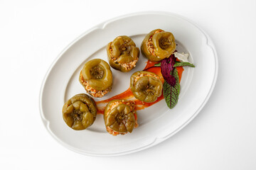 Sweet peppers stuffed with rice, vegetables and meat, baked in the oven. Banquet festive dishes....