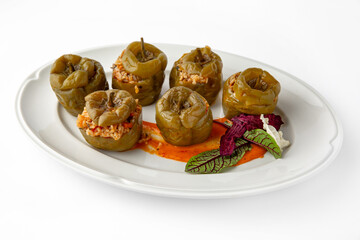 Sweet peppers stuffed with rice, vegetables and meat, baked in the oven. Banquet festive dishes. Gourmet restaurant menu. White background. 
