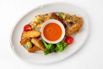Fish fillets, chicken in batter with vegetables. Banquet festive dishes. Gourmet restaurant menu. White background.