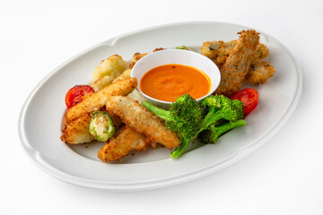 Fish fillets, chicken in batter with vegetables. Banquet festive dishes. Gourmet restaurant menu. White background.