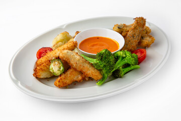 Fish fillets, chicken in batter with vegetables. Banquet festive dishes. Gourmet restaurant menu. White background.
