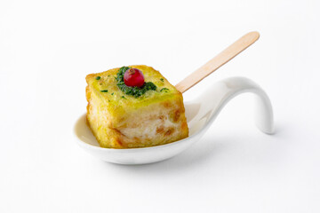 A portion of zucchini in batter with pesto sauce and currants. Beautifully decorated catering...