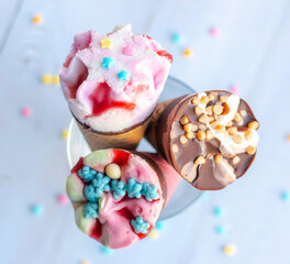 Colorful ice cream cones with a variety of toppings.