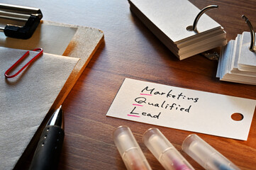 The words Marketing Qualified Lead written in a word card with colored pens. Close-up.