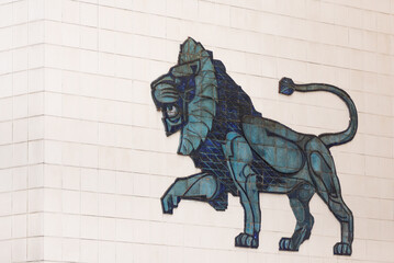 Lion on the house in Brno. Old bas-relief in the form of a lion in the Czech city. Mosaic made of green material