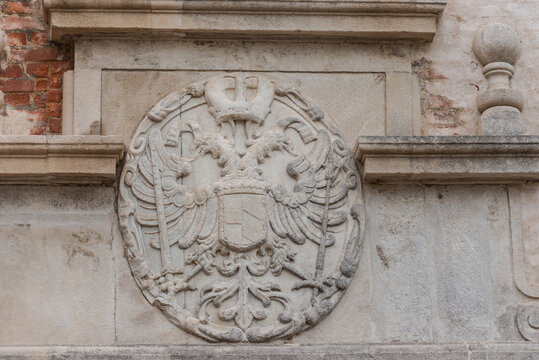 Old coat of arms on a house in the city of Brno. Bas-relief in the form of a two-headed eagle in the Czech city - Powered by Adobe