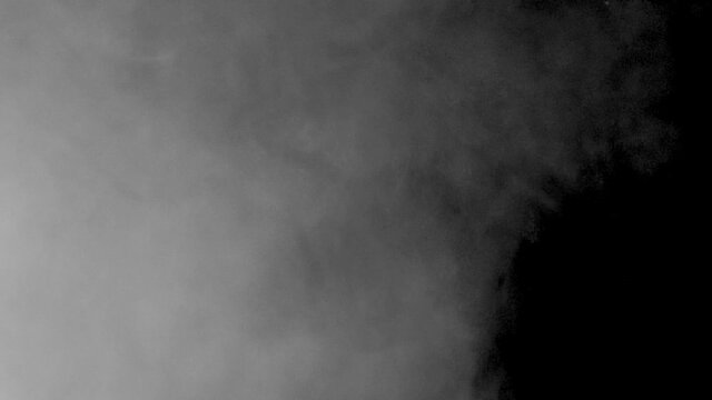 White smoke on a black background slow motion. Start moving the cloud from bottom to top slowly. The concept of transitions for video editing using the alpha channel.