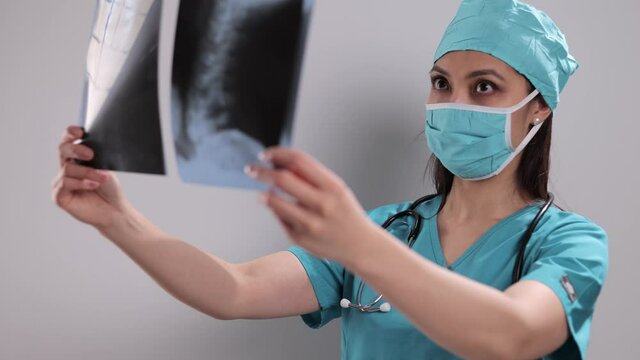 Female doctor looks at X-rays - studio shooting