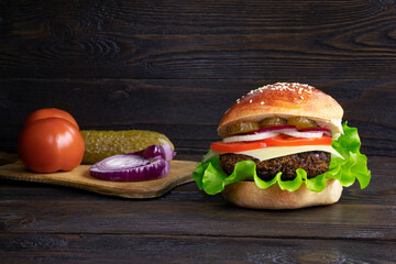 Cheeseburger isolated on a wooden background. Hamburger with cheese. Burger isolated