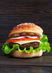 Cheeseburger isolated on a wooden background. Hamburger with cheese. Burger isolated