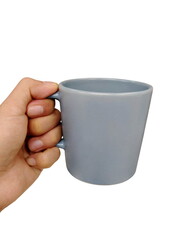 Hand holding Gray ceramic coffee cup on white background.