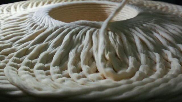 Cotton yarn production. Machinery and equipment in the workshop. Interior of industrial textile factory. 4K. close up. slow motion.