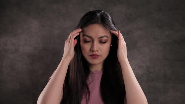 Young woman suffers from headache - studio shooting