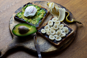 Avocado and poached egg on toast with Vegemite and banana with vegemite on Toast