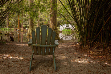 Adirondack chair and bridge in garden