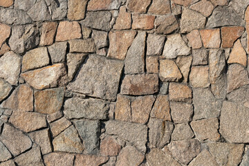 Stone wall of granite close-up, texture, background
