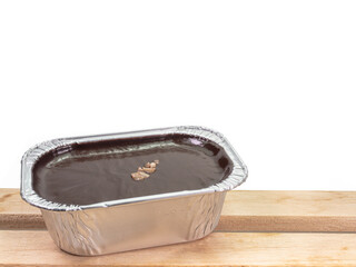 Chocolate fudge cake, a close up of homemade mousse brownie cake in aluminum foil cup isolated on...